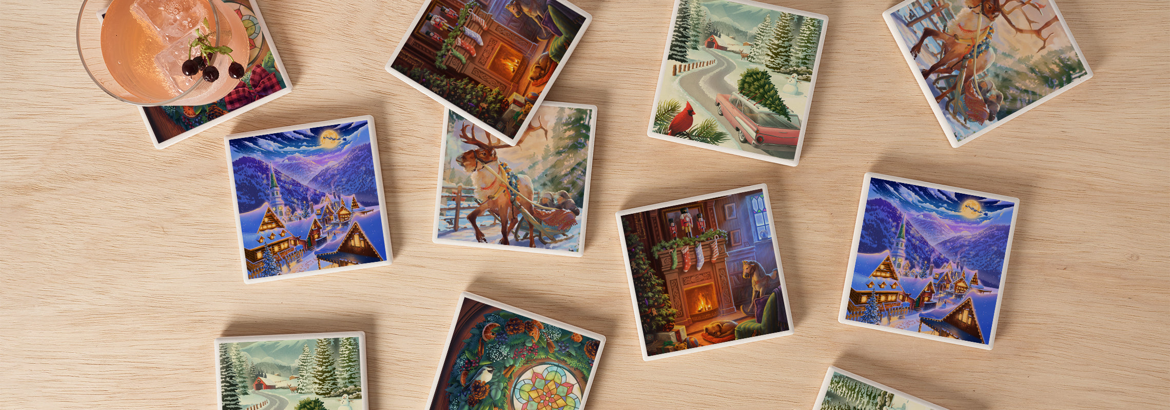 Holiday themed coasters seen from above, resting on a light wood surface with a drink in the top left corner.